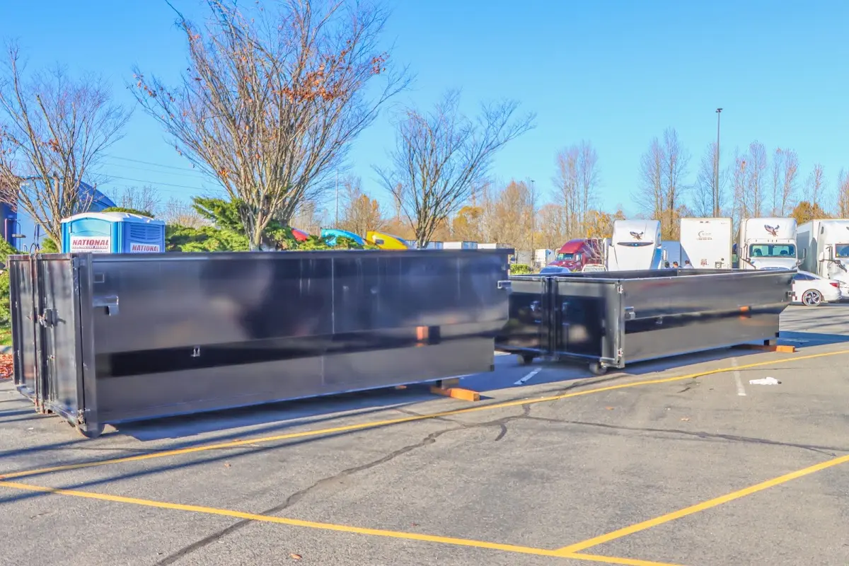 Professional dumpster rental service with roll-off container on residential driveway in Waterville